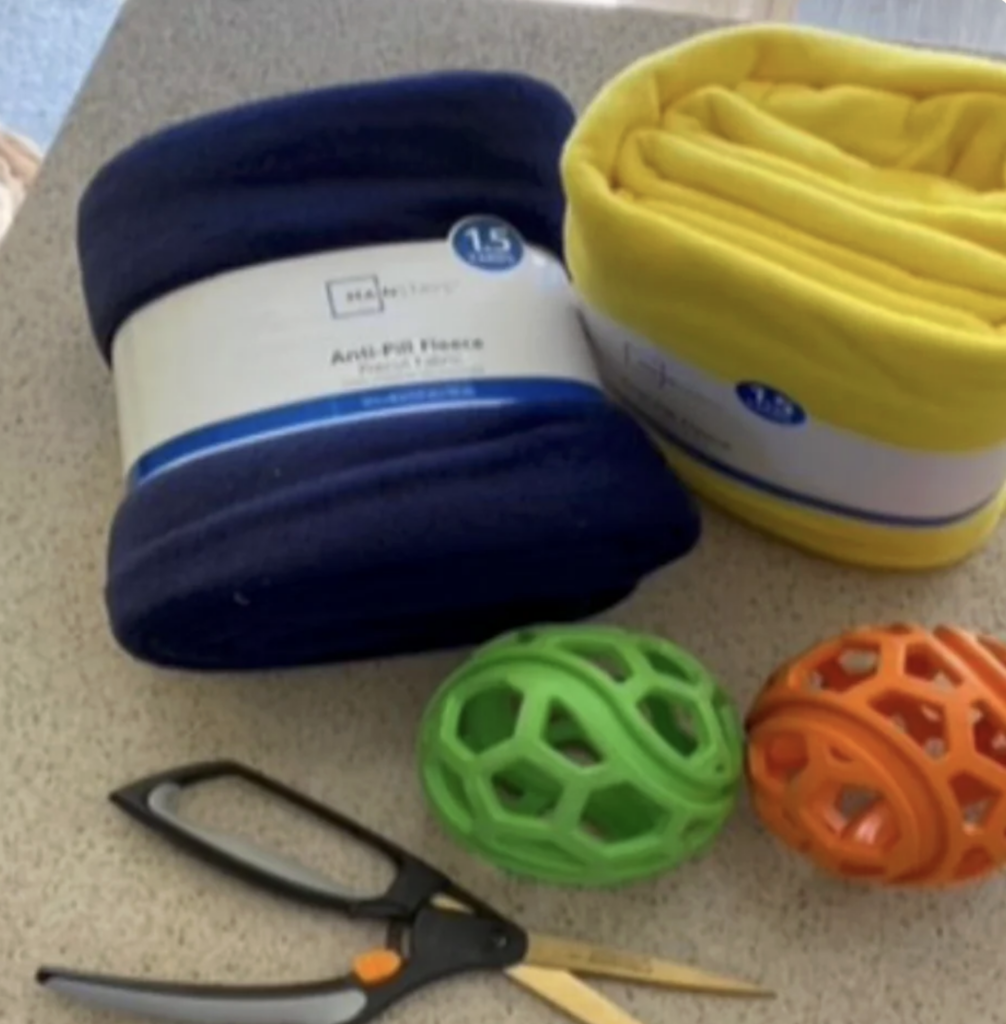fleece fabric, rubber balls, and scissors to make a fleece tug toy for dogs